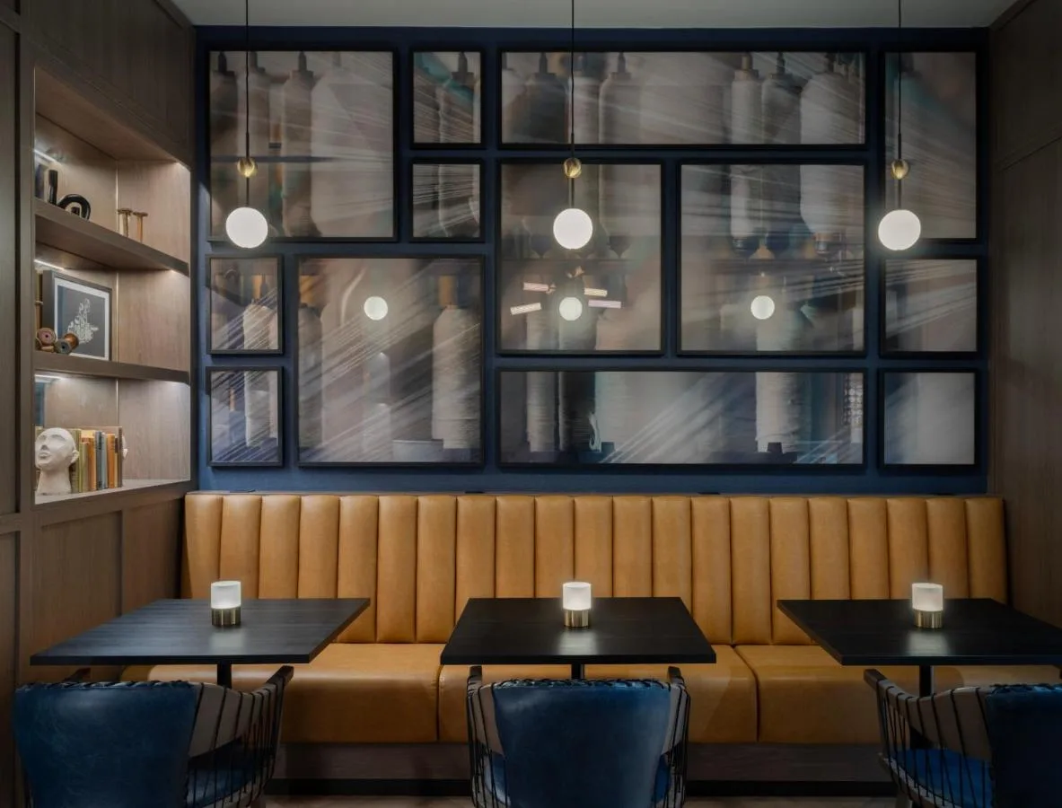 a restaurant with two tables and a bench at Glasgow Marriott Hotel in Glasgow