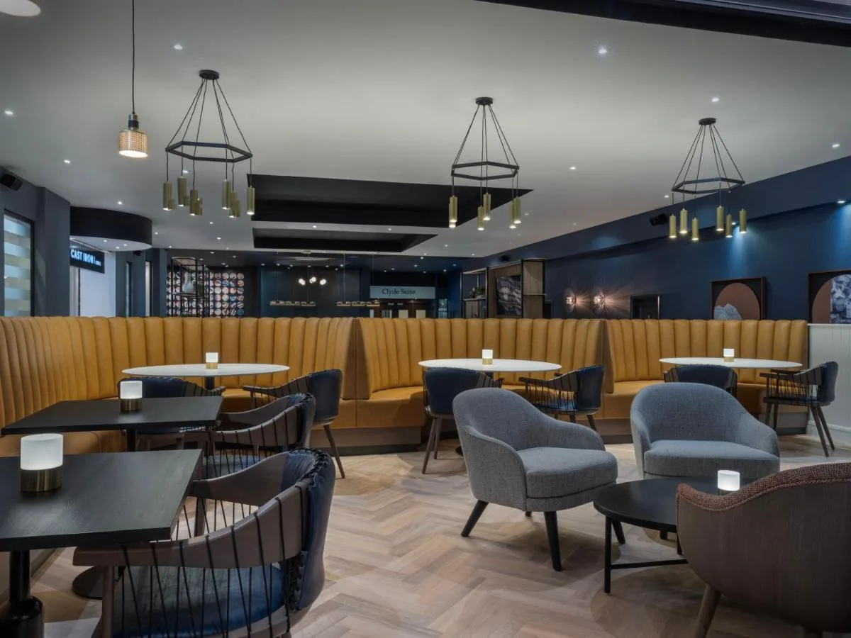 a restaurant with tables and chairs and a bar at Glasgow Marriott Hotel in Glasgow