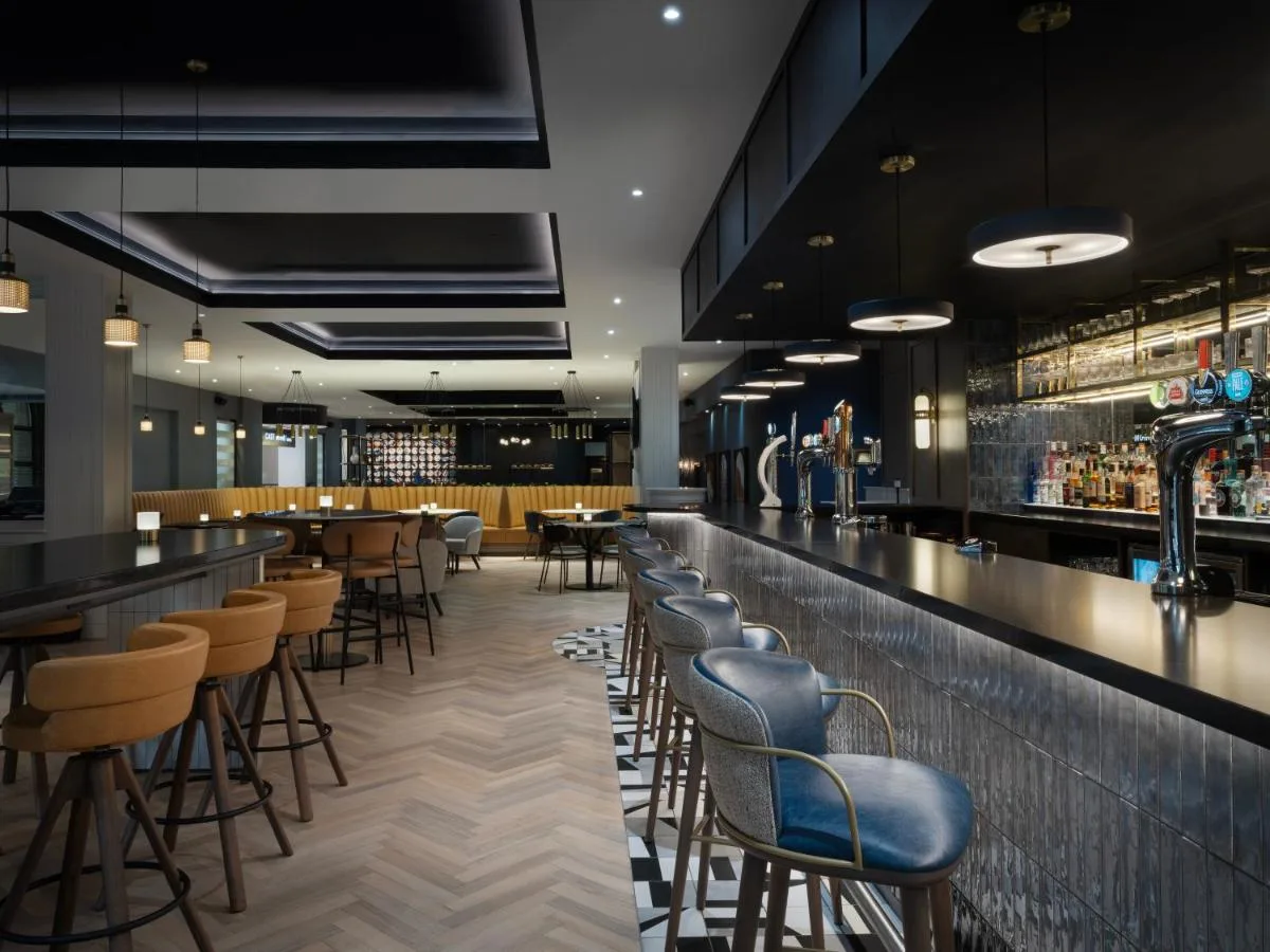 a bar at a restaurant with stools at Glasgow Marriott Hotel in Glasgow