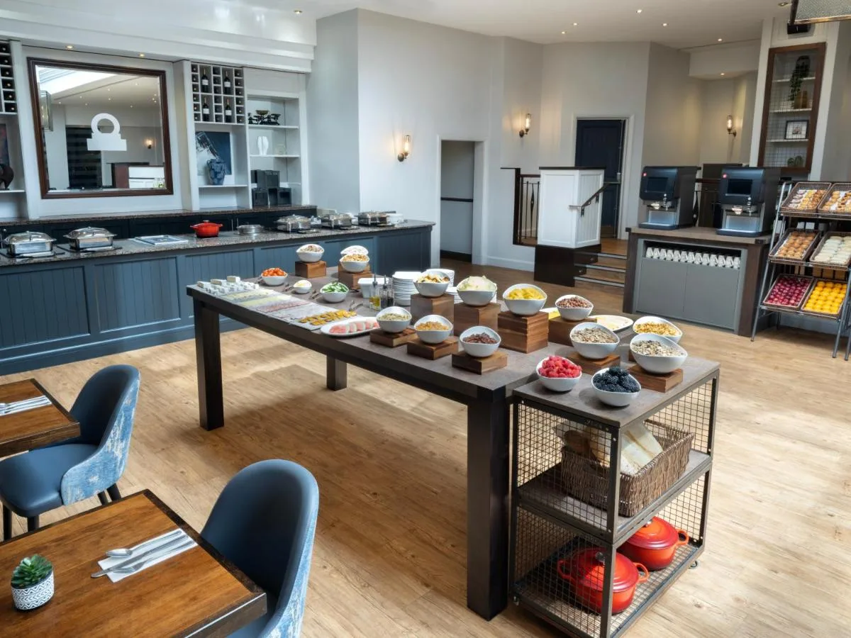 a bakery with a table with cupcakes on it at Glasgow Marriott Hotel in Glasgow